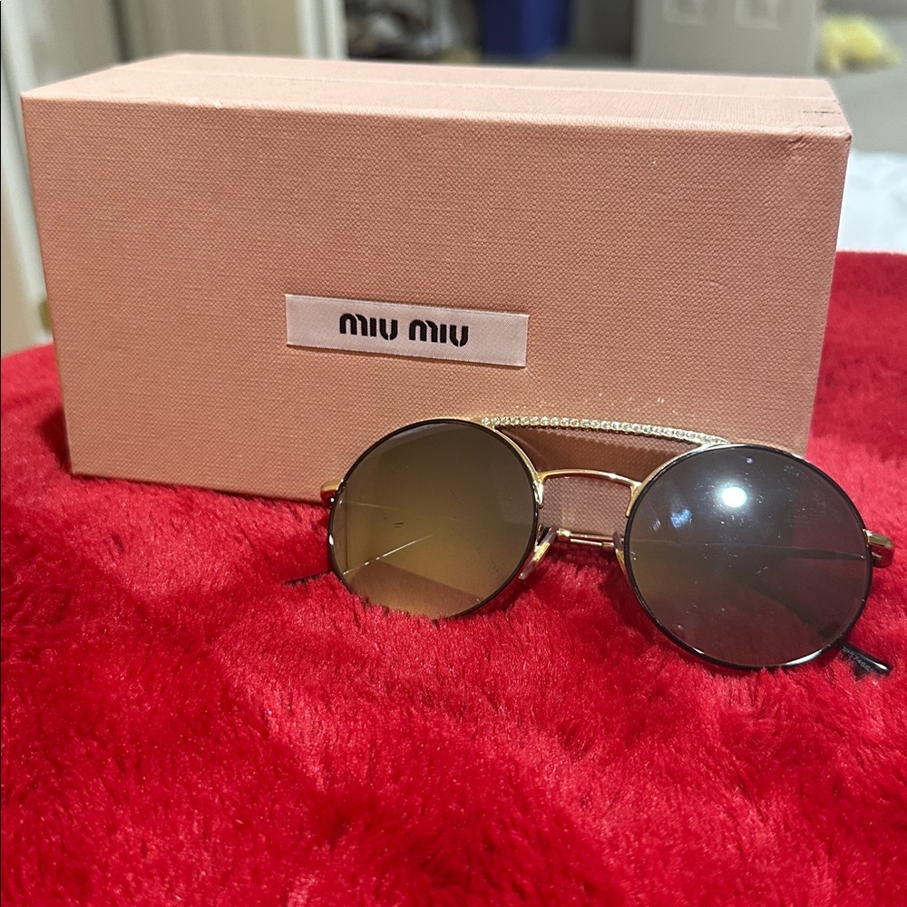 Miu Miu Round Sunglasses with Gold Frame and Black Lenses